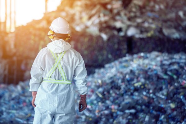 worker looking at a huge landfill